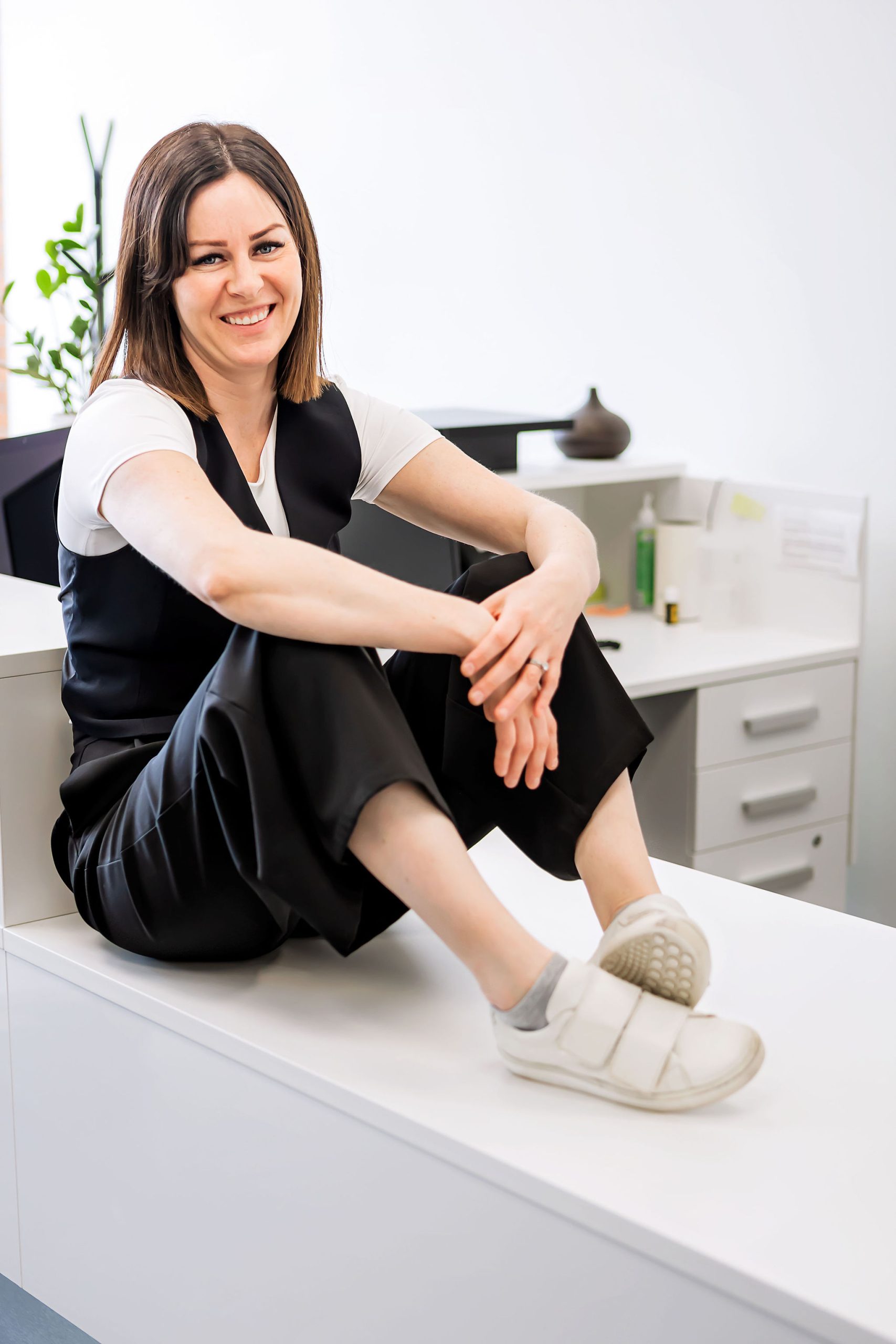 Tynelle Badinski talking with a client in a bright office