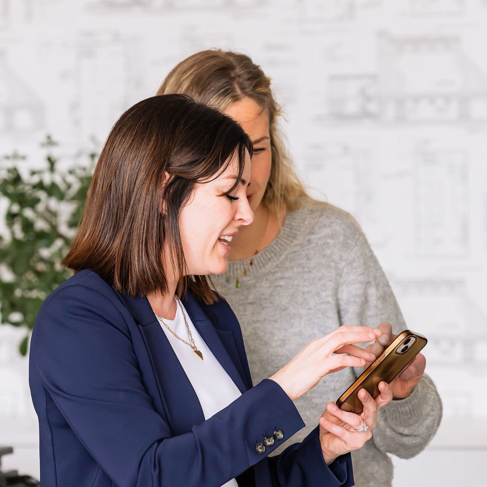 Tynelle Badinski showing a client something on her phone