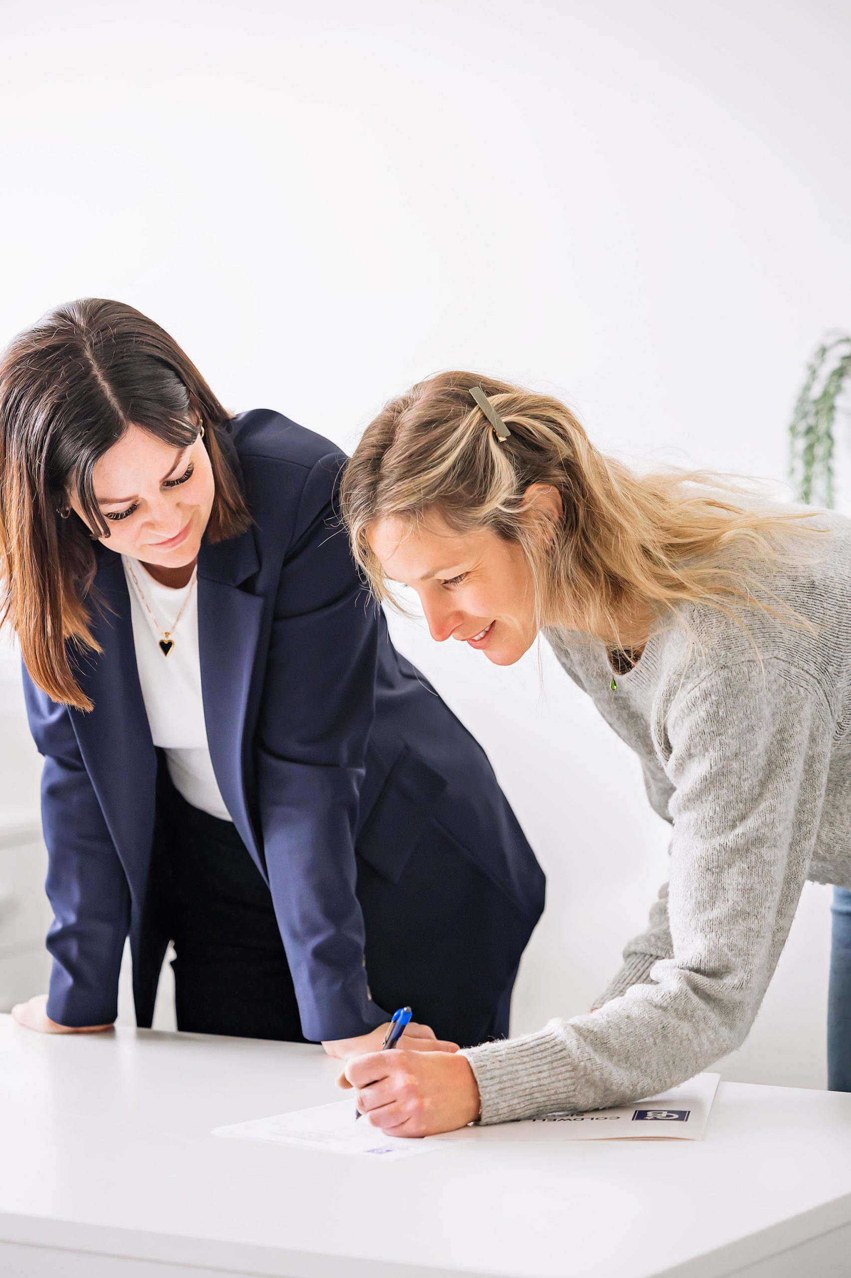 Tynelle Badinski going over paperwork at a desk with a client